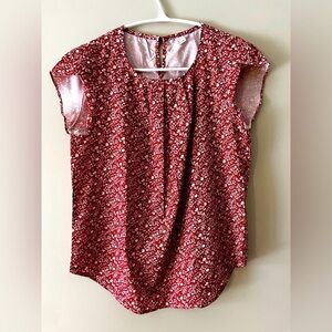Women’s size medium red printed blouse with button closure in back